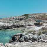Troviamo un altro gruppo di bagnanti, anch�essi riparati sotto una capanna improvvisata. Siamo in una zona chiamata  �Cala dei ladroni� caratterizzata da uno scivolo naturale che porta al mare